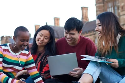 A group of students studies on a college campus