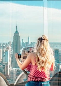 A young woman looks over the NYC skyline